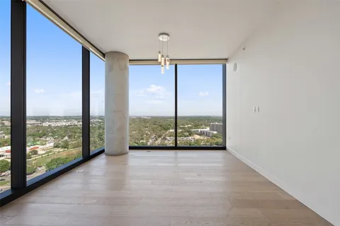a view of an empty room with windows and city view