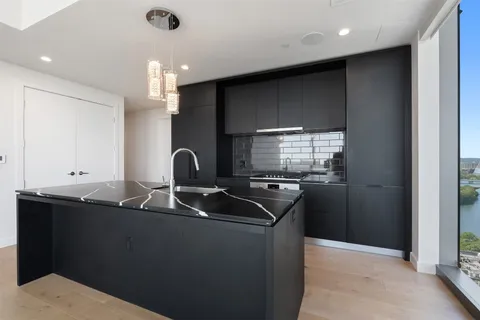 a kitchen with a sink and refrigerator