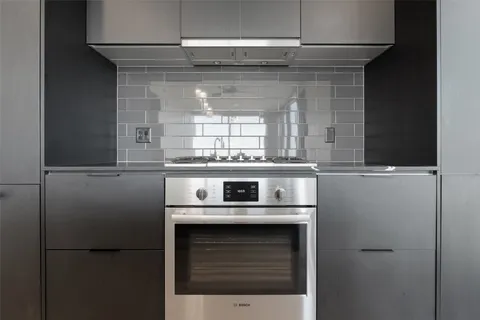 a stove top oven sitting inside of a kitchen
