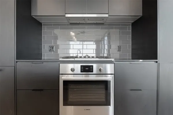 a stove top oven sitting inside of a kitchen
