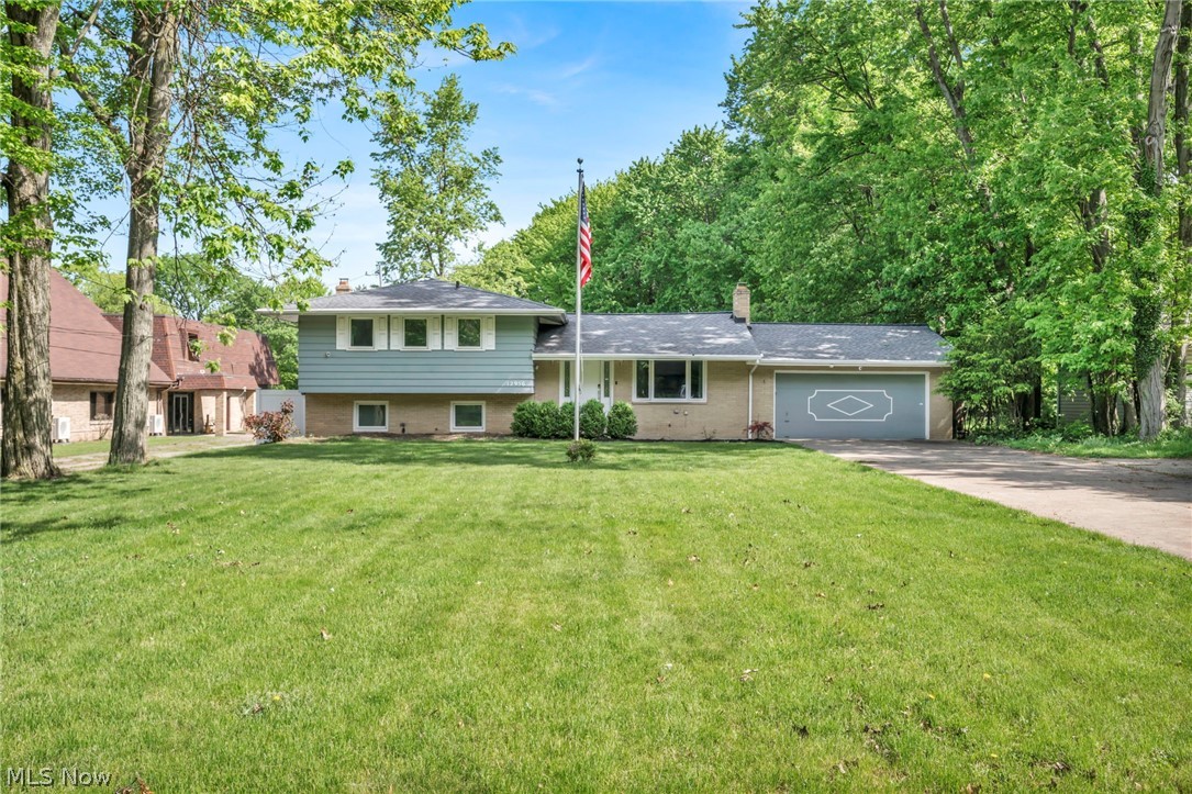 12956 Huffman Road Parma, OH 44130 - Photo 2 of 49 Tri-level home featuring a garage and a front lawn