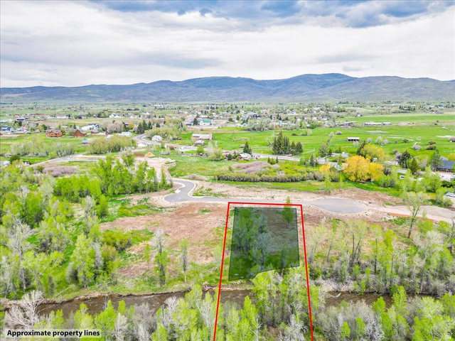 829 River Haven Road, Unit 111 Oakley, UT 84055 - Photo 8 of 12 Aerial depiction of property outlined in red, featuring a river frontage, mature trees, and mountainous terrain in the background