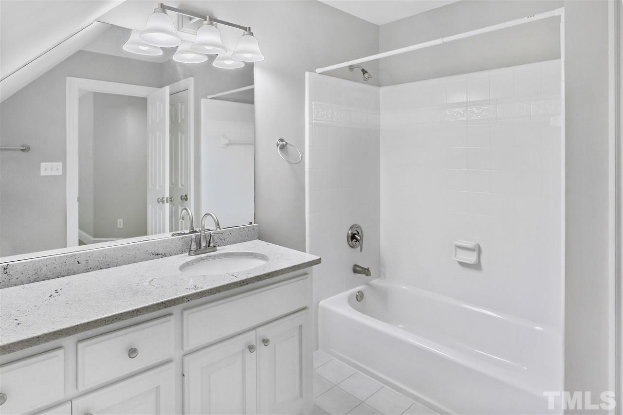 512 Pendleton Lake Road Raleigh, NC 27614 - Photo 20 of 30 a bathroom with a granite countertop sink mirror and a bathtub