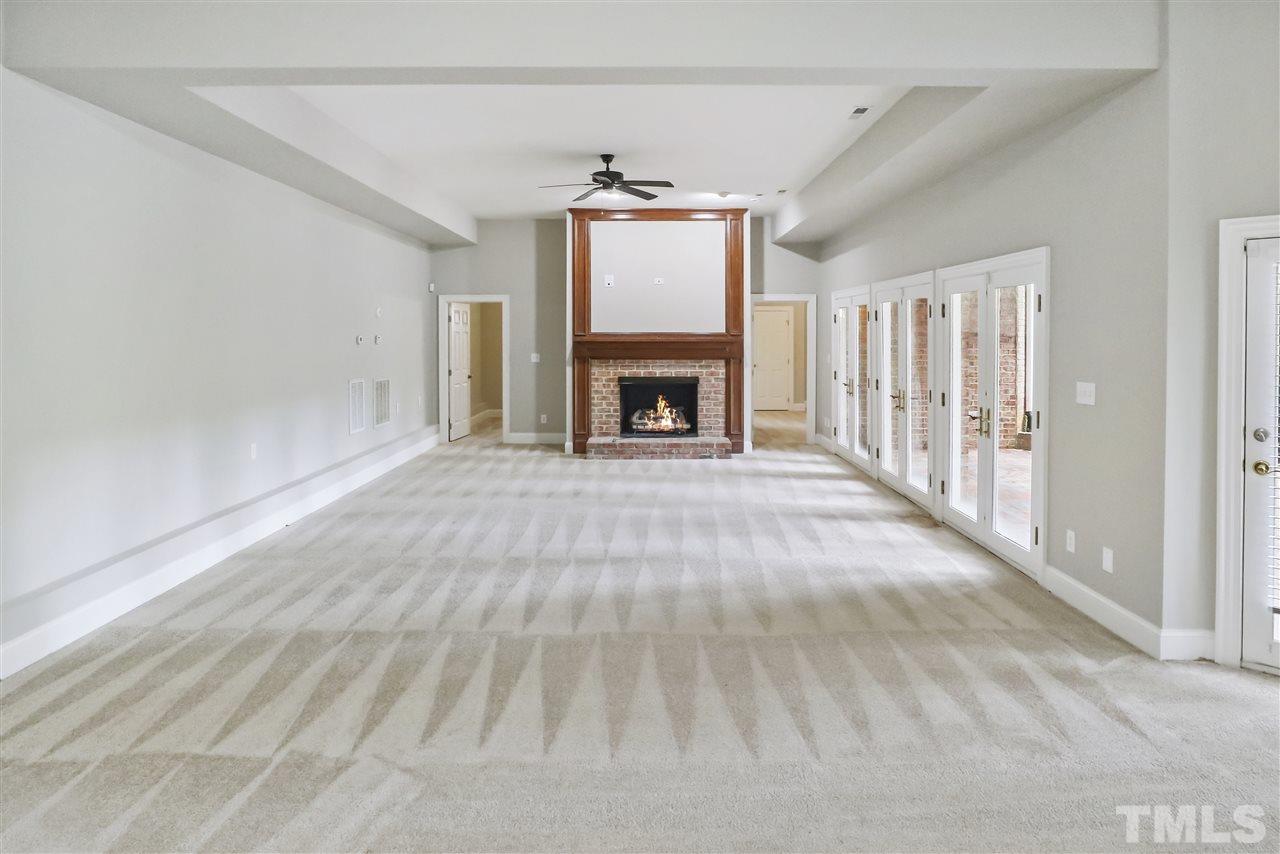 512 Pendleton Lake Road Raleigh, NC 27614 - Photo 21 of 30 a view of an empty room with a fireplace and a window