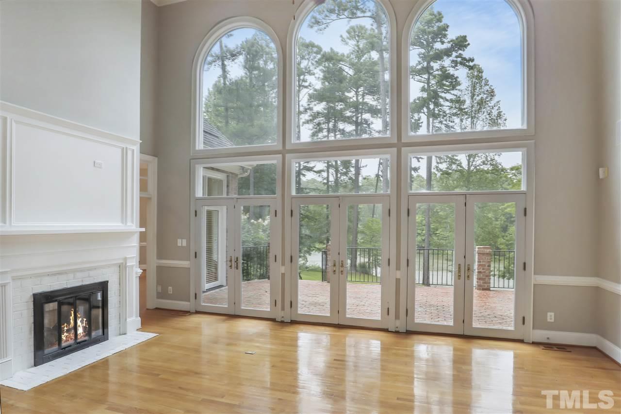 512 Pendleton Lake Road Raleigh, NC 27614 - Photo 4 of 30 a view of an empty room with wooden floor and a fireplace