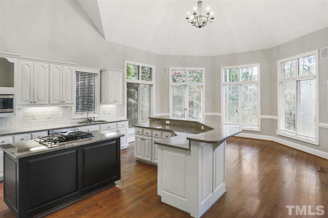 512 Pendleton Lake Road Raleigh, NC 27614 - Photo 7 of 30 a kitchen with stainless steel appliances granite countertop a stove a sink and a microwave