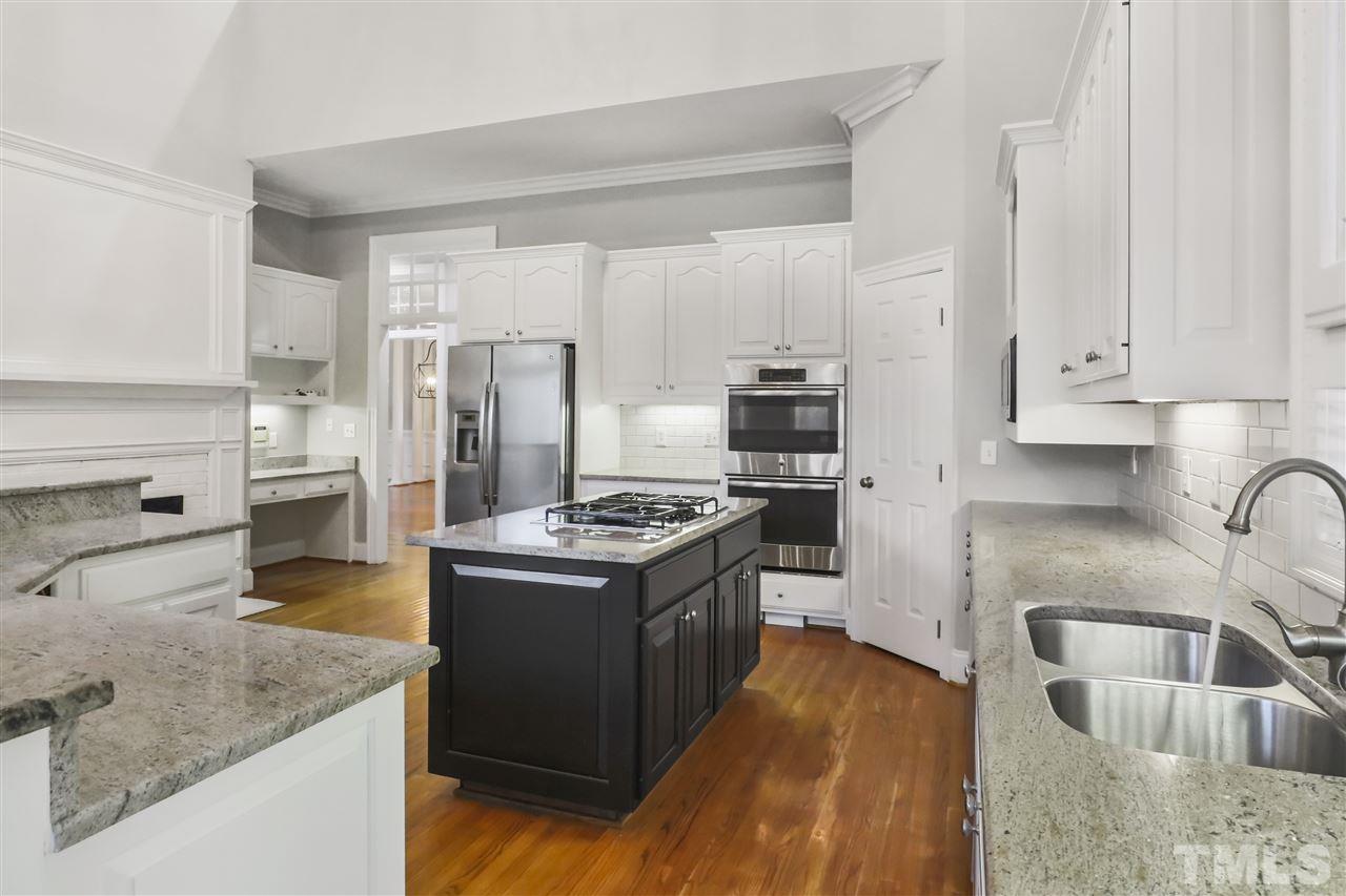 512 Pendleton Lake Road Raleigh, NC 27614 - Photo 8 of 30 a kitchen with stainless steel appliances granite countertop a sink stove and refrigerator