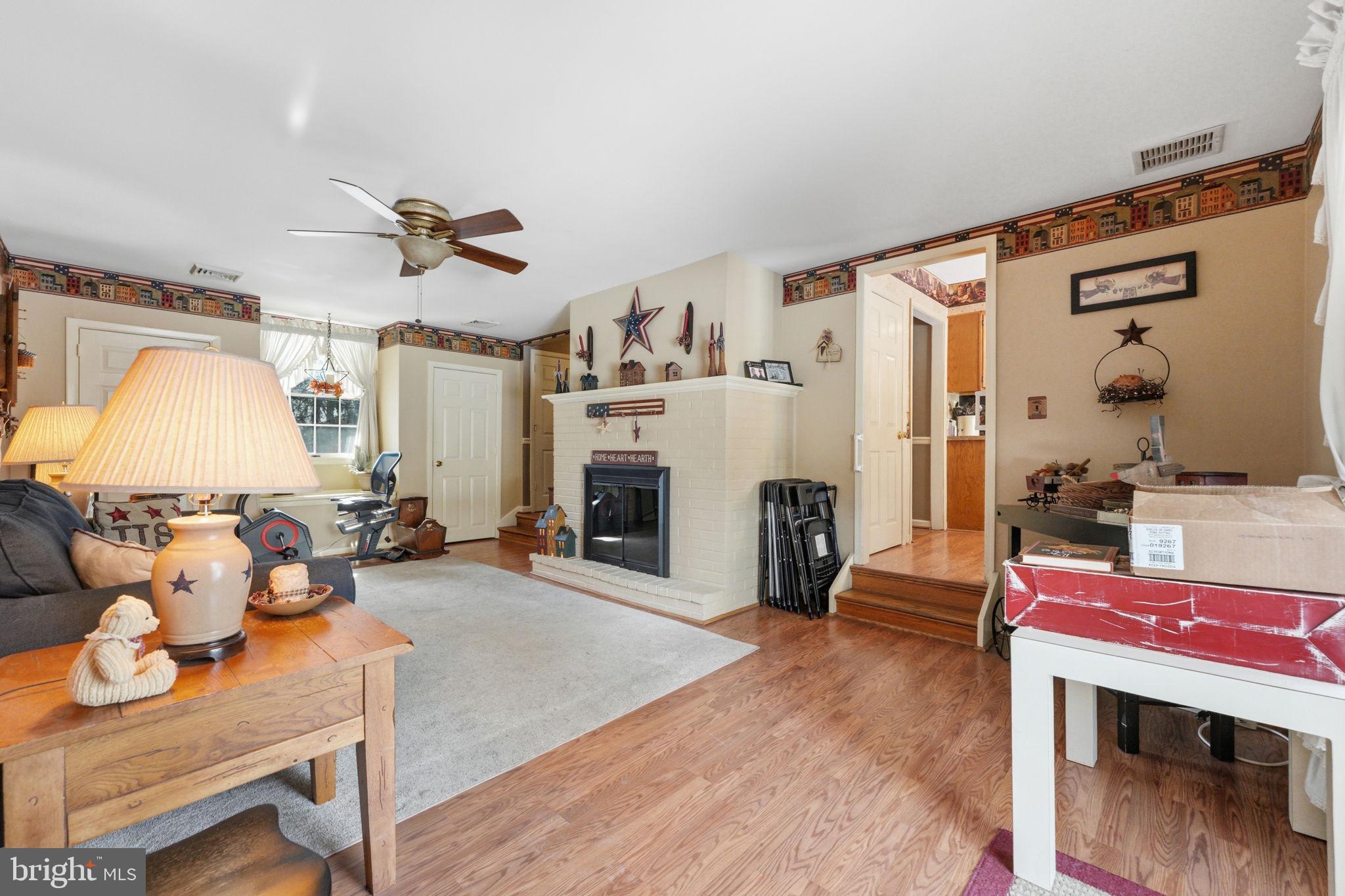 1848 Brackenville Road Hockessin, DE 19707 - Photo 14 of 37 a living room with furniture a fireplace and a table