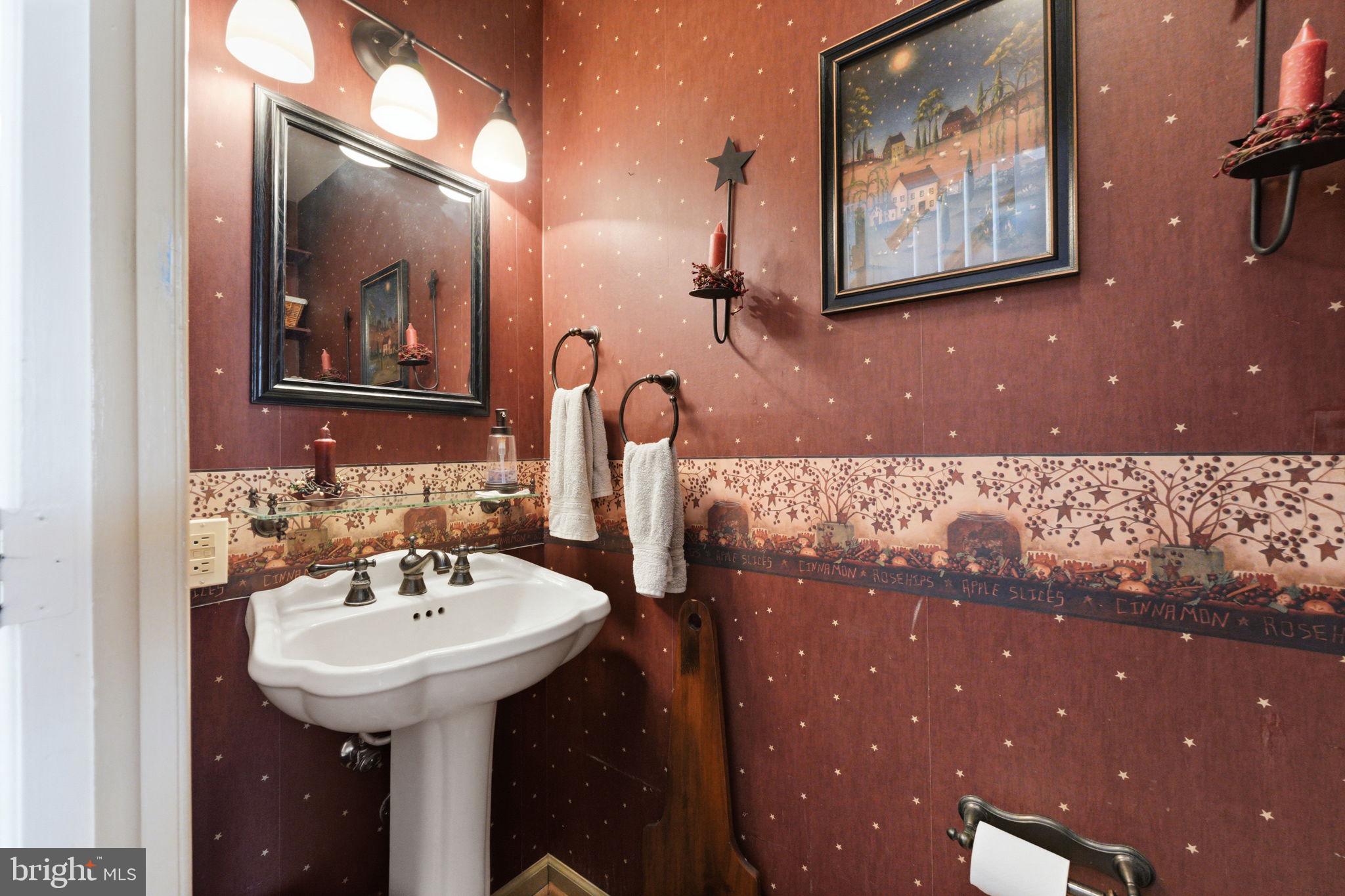1848 Brackenville Road Hockessin, DE 19707 - Photo 16 of 37 a bathroom with a sink and a mirror