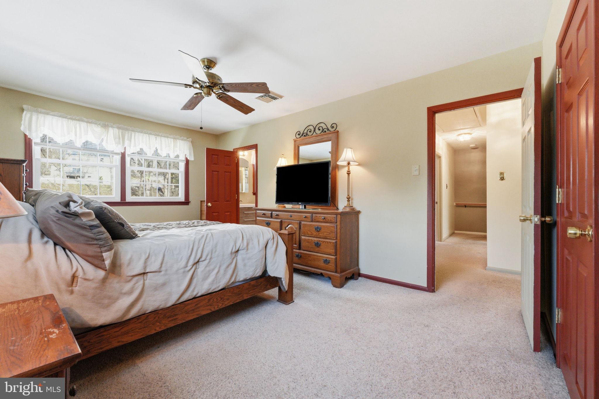 1848 Brackenville Road Hockessin, DE 19707 - Photo 18 of 37 a spacious bedroom with a bed and a flat screen tv