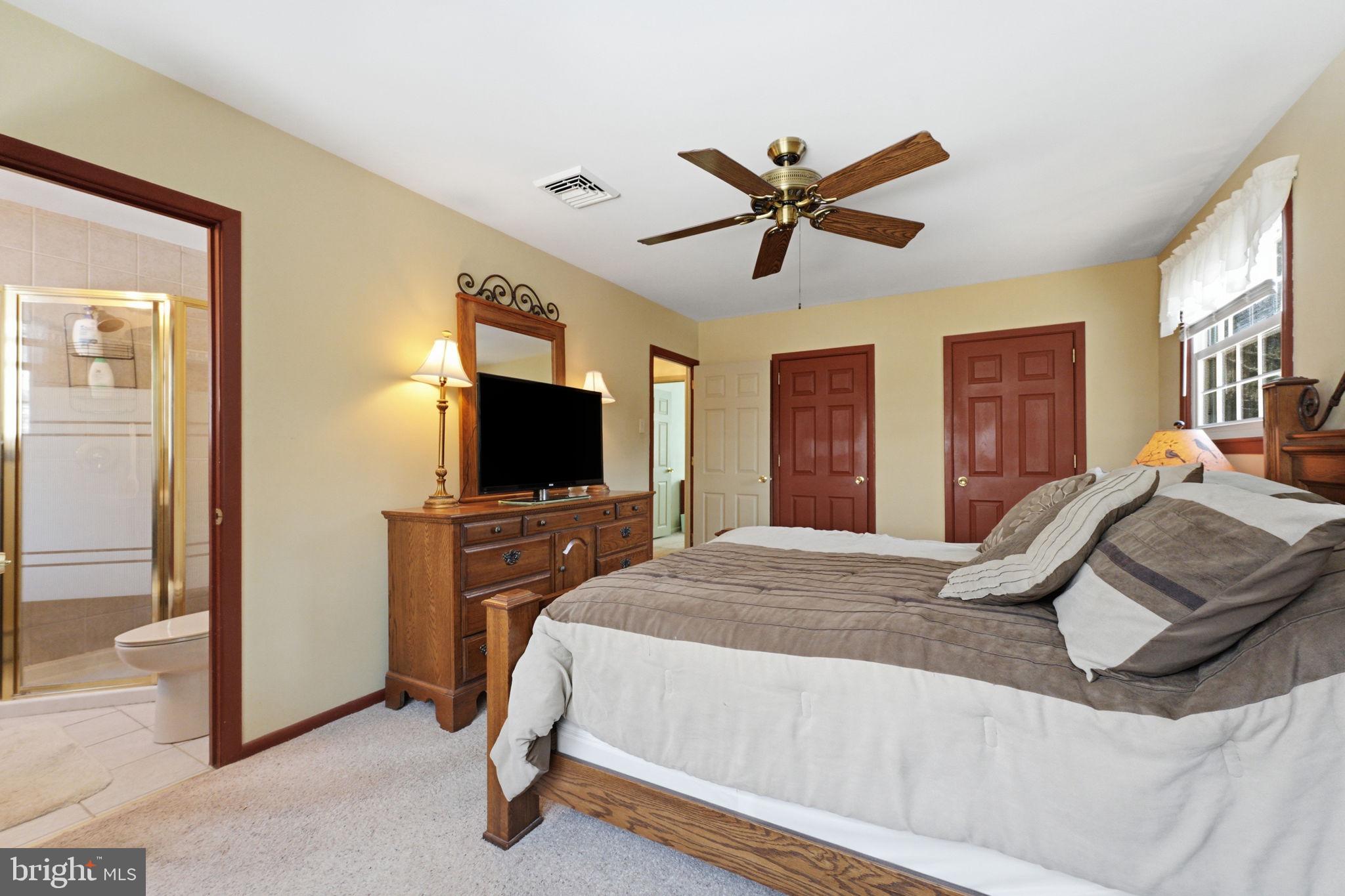 1848 Brackenville Road Hockessin, DE 19707 - Photo 19 of 37 a bedroom with a bed and a flat screen tv