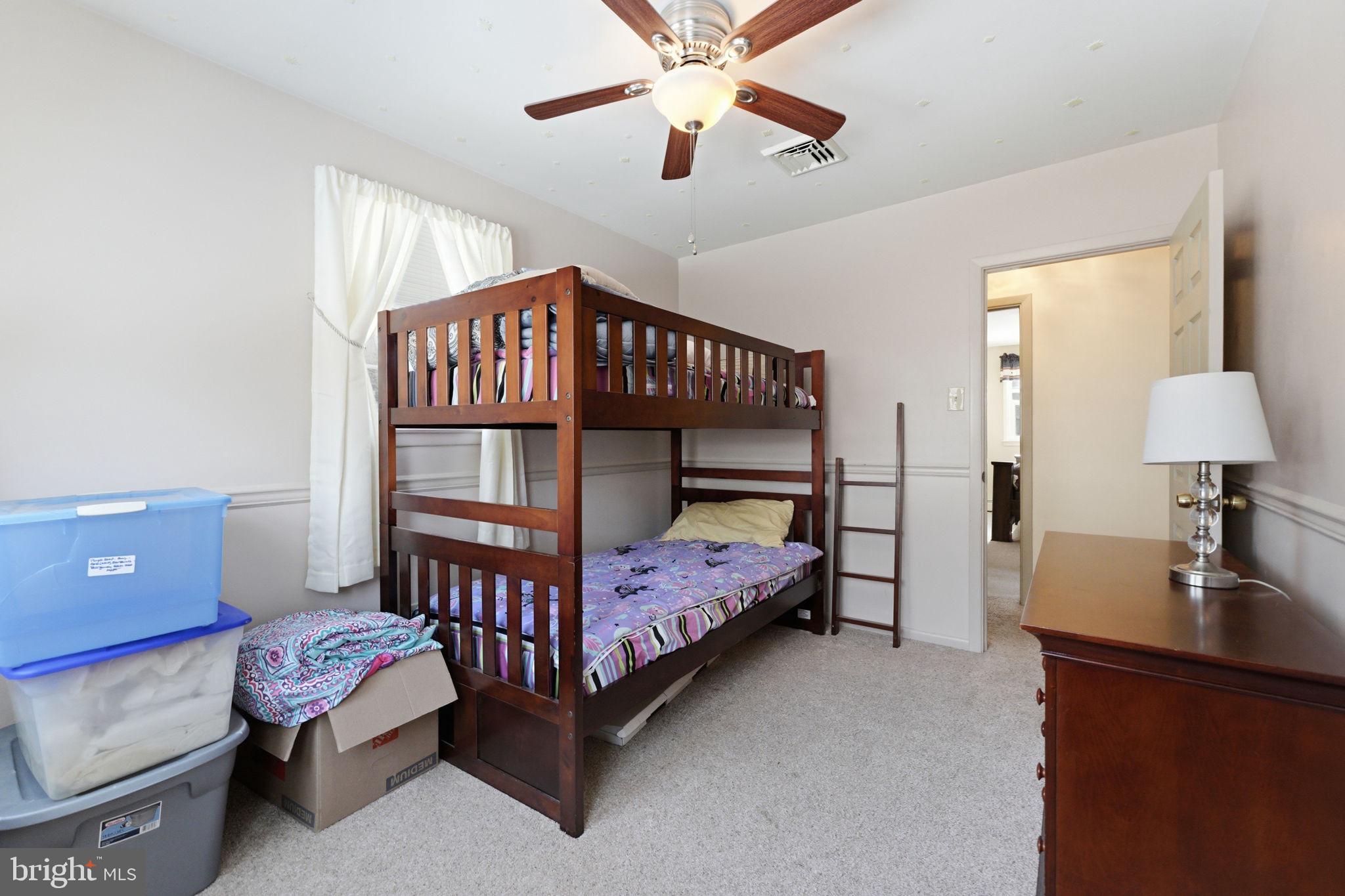 1848 Brackenville Road Hockessin, DE 19707 - Photo 23 of 37 a bedroom with a bed and a chandelier