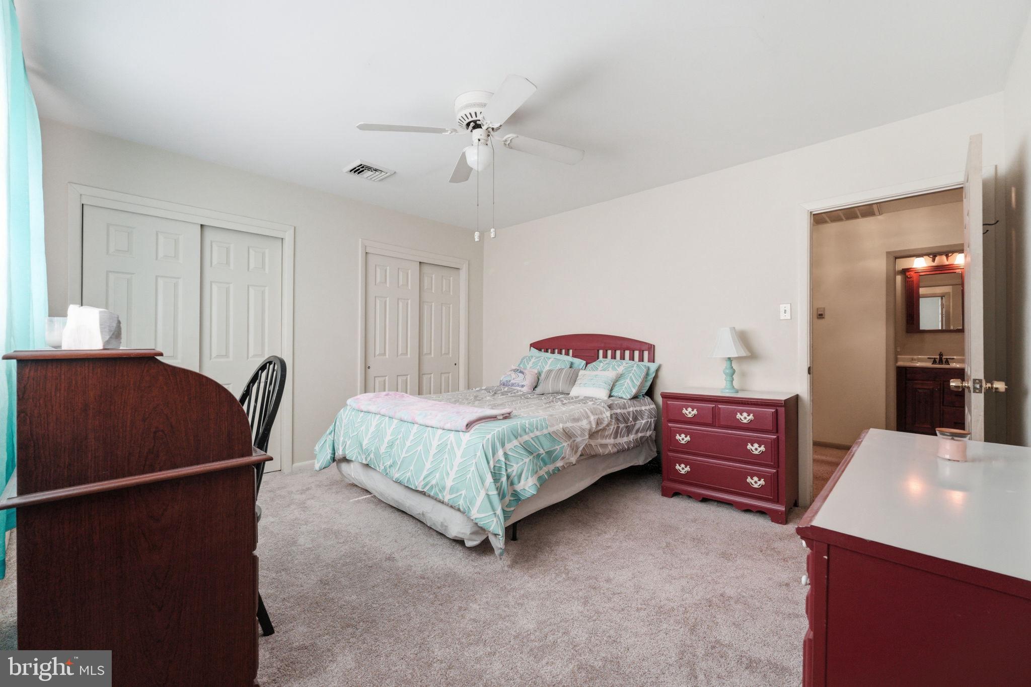1848 Brackenville Road Hockessin, DE 19707 - Photo 24 of 37 a bedroom with a bed and dresser with mirror