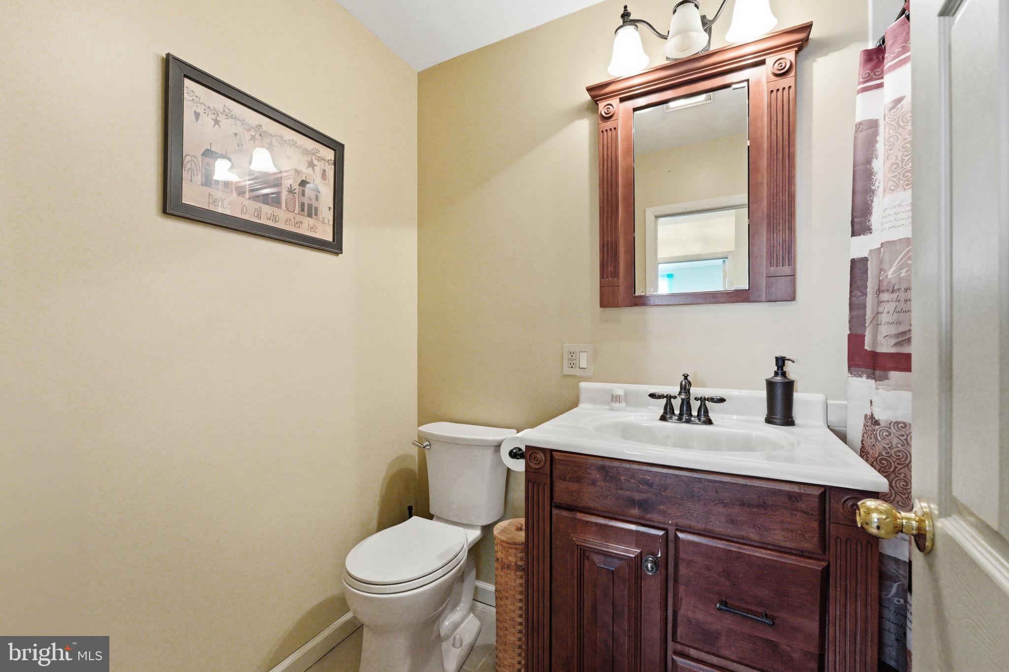 1848 Brackenville Road Hockessin, DE 19707 - Photo 25 of 37 a bathroom with a toilet sink and mirror