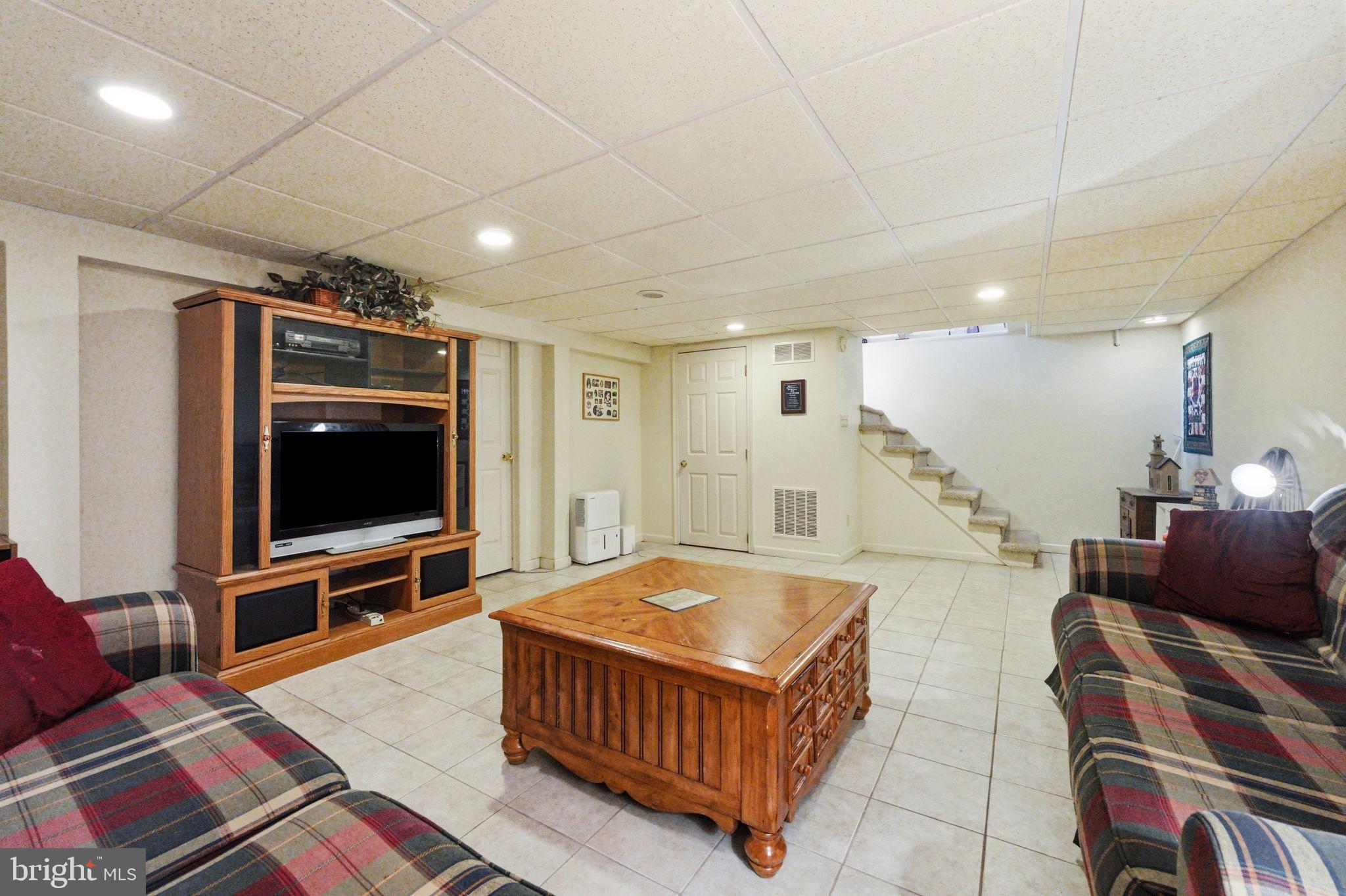 1848 Brackenville Road Hockessin, DE 19707 - Photo 28 of 37 a living room with furniture and a flat screen tv