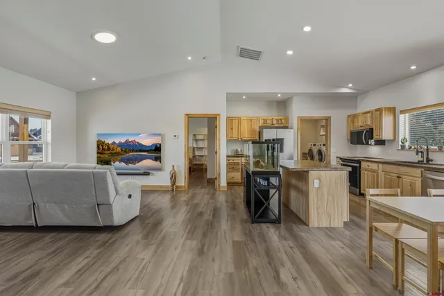 a kitchen with stainless steel appliances granite countertop a sink stove and table