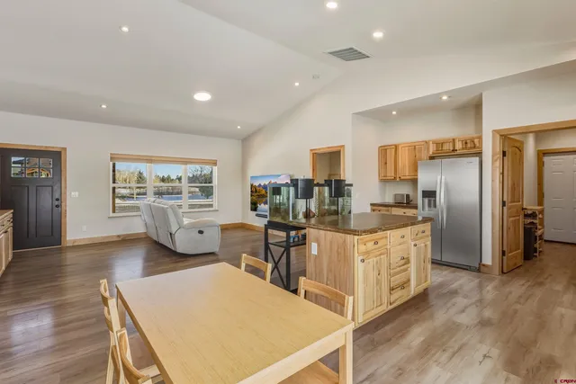 a living room with furniture and kitchen view