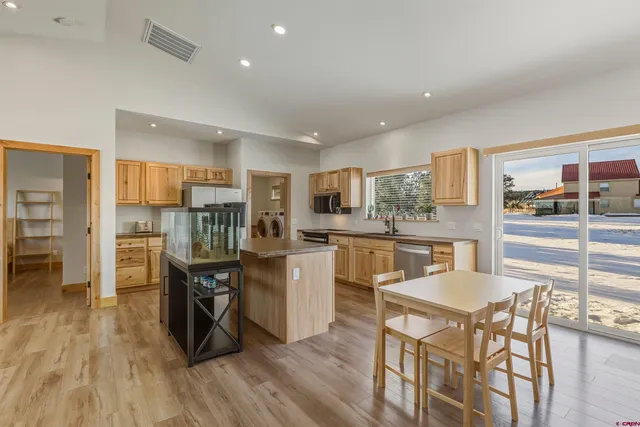a living room with stainless steel appliances granite countertop lots of counter top space and furniture