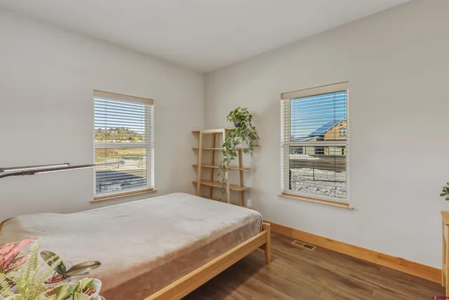 a living room with furniture and a air conditioner vent