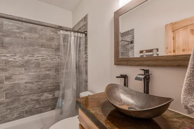 a bedroom with a bed and a potted plant