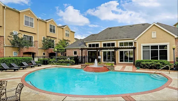 a view of a swimming pool with outdoor seating