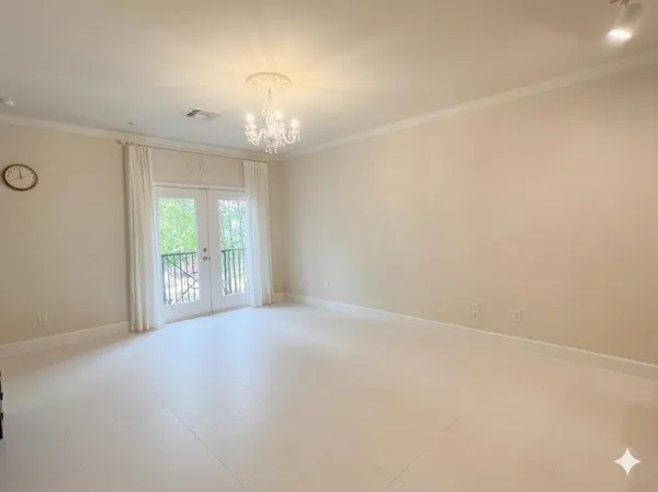 an empty room with windows and outdoor view