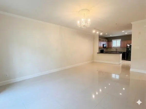 a view of a kitchen with a sink and a refrigerator