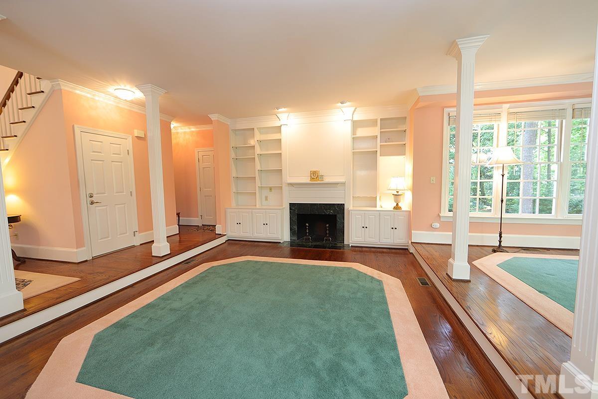 7600 Pinewild Court Raleigh, NC 27615 - Photo 13 of 52 a spacious bedroom with a large window and a fireplace