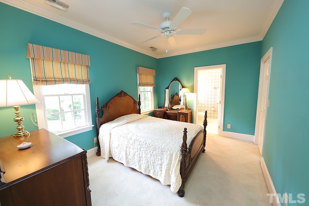7600 Pinewild Court Raleigh, NC 27615 - Photo 36 of 52 a bedroom with a bed and a table
