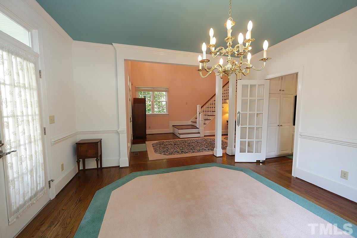 7600 Pinewild Court Raleigh, NC 27615 - Photo 10 of 52 a bedroom with a bed and a chandelier