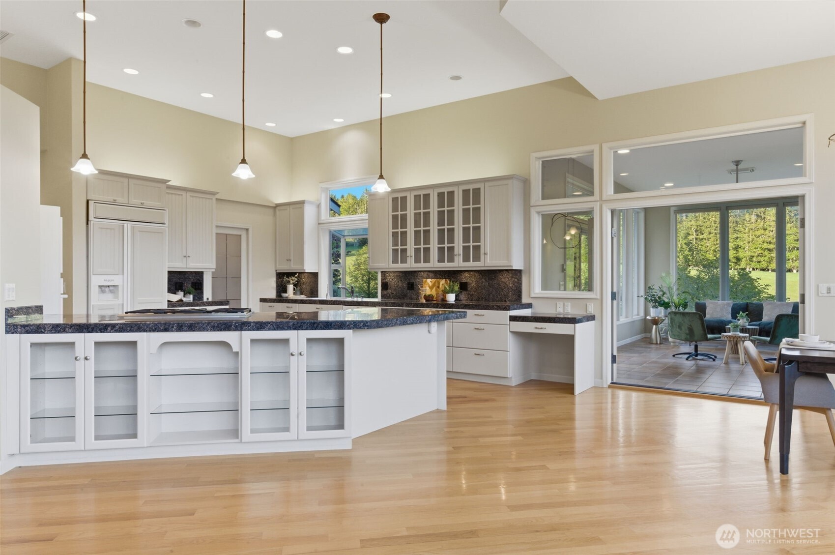 2263 Lost Mountain Road Sequim, WA 98382 - Photo 11 of 40 a large white kitchen with a large window and stainless steel appliances
