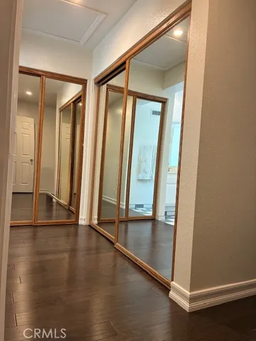 an empty room with wooden floor and glass door