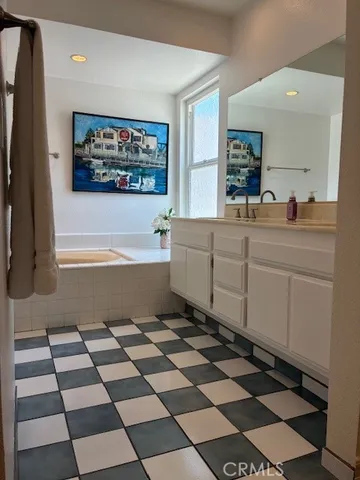 a spacious bathroom with a black white checkered floor