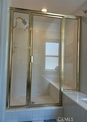 a bathroom with a glass shower door and a mirror