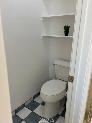 a white toilet sitting next to a shower