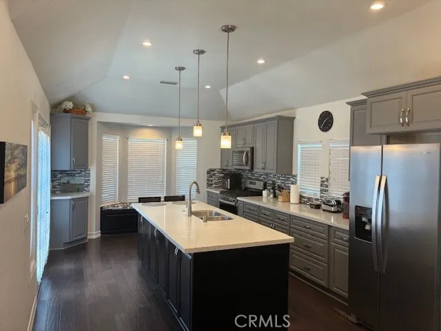 a kitchen with refrigerator cabinets and stove