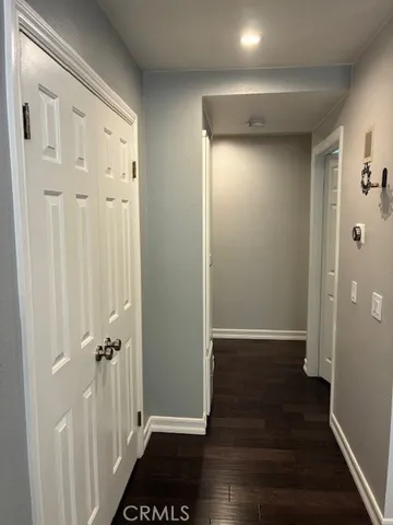 a view of a hallway with wooden floor