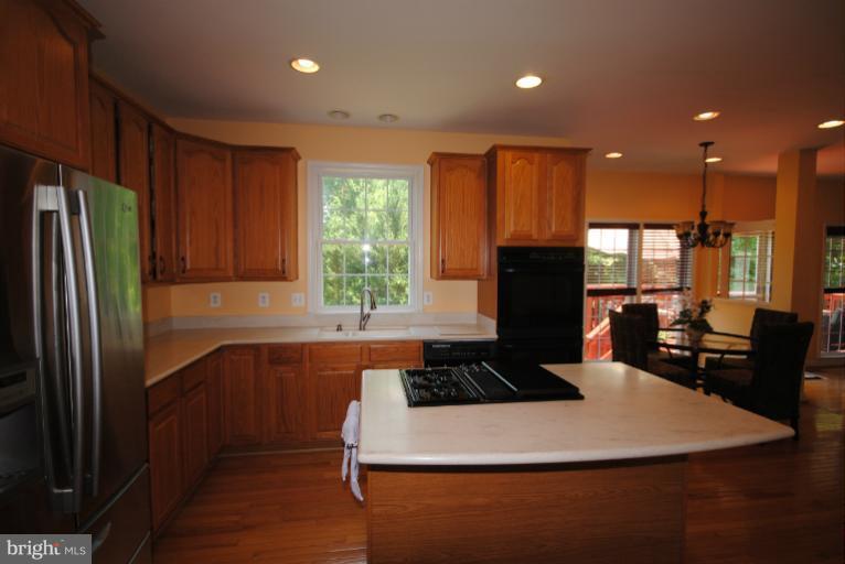a kitchen with a refrigerator and a stove top oven