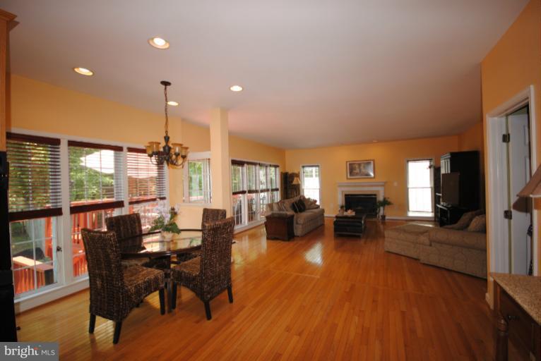 20334 Cliftons Point Street Sterling, VA 20165 - Photo 12 of 30 a view of a dining room with furniture window and wooden floor