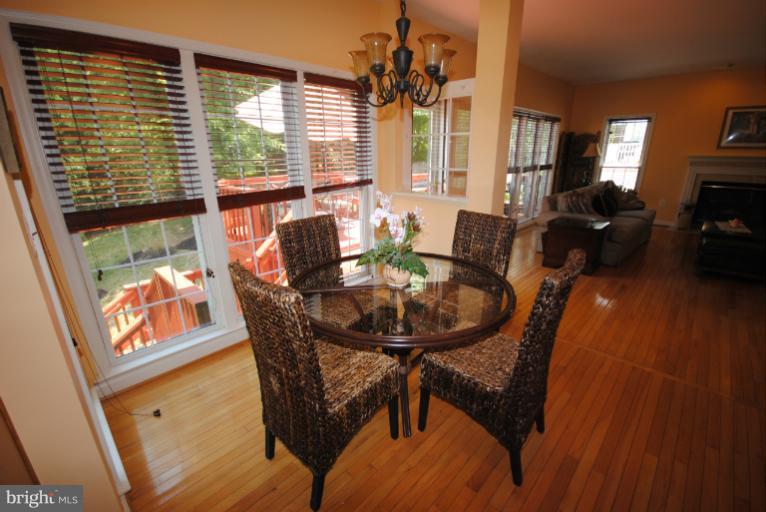 20334 Cliftons Point Street Sterling, VA 20165 - Photo 13 of 30 a view of a dining room with furniture window and wooden floor