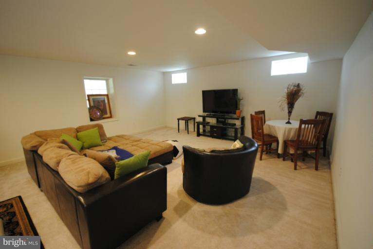 20334 Cliftons Point Street Sterling, VA 20165 - Photo 25 of 30 a living room with furniture and a flat screen tv