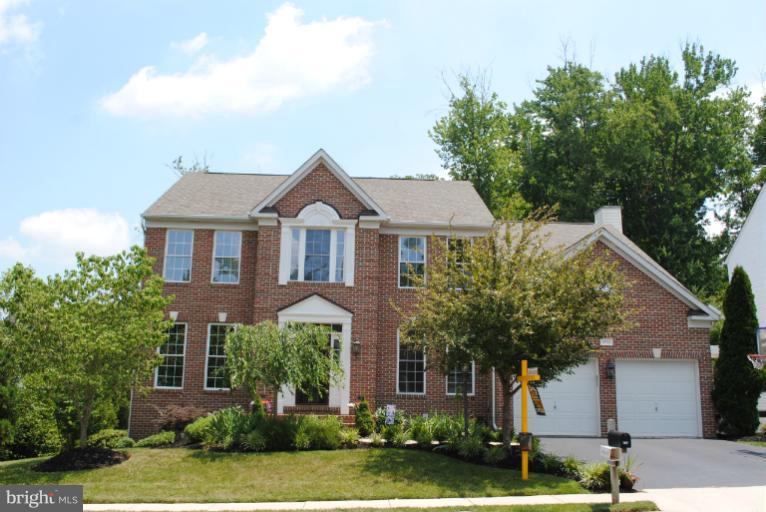 20334 Cliftons Point Street Sterling, VA 20165 - Photo 30 of 30 a front view of a house with a yard and garage