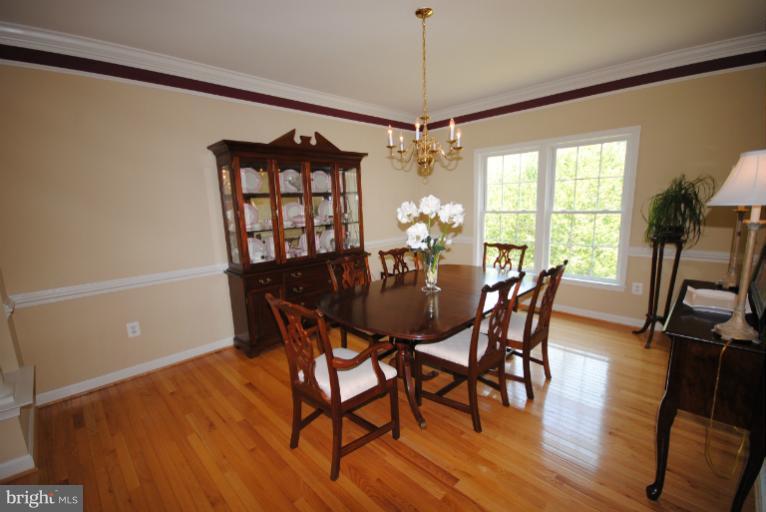 20334 Cliftons Point Street Sterling, VA 20165 - Photo 7 of 30 a view of a dining room with furniture window and wooden floor