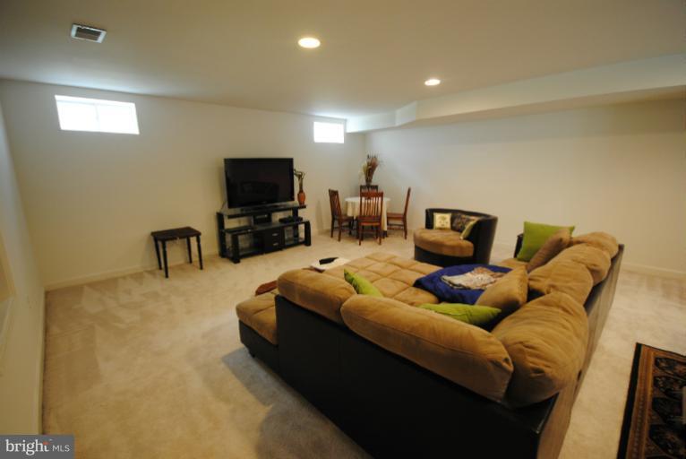 20334 Cliftons Point Street Sterling, VA 20165 - Photo 9 of 30 a living room with furniture and a flat screen tv