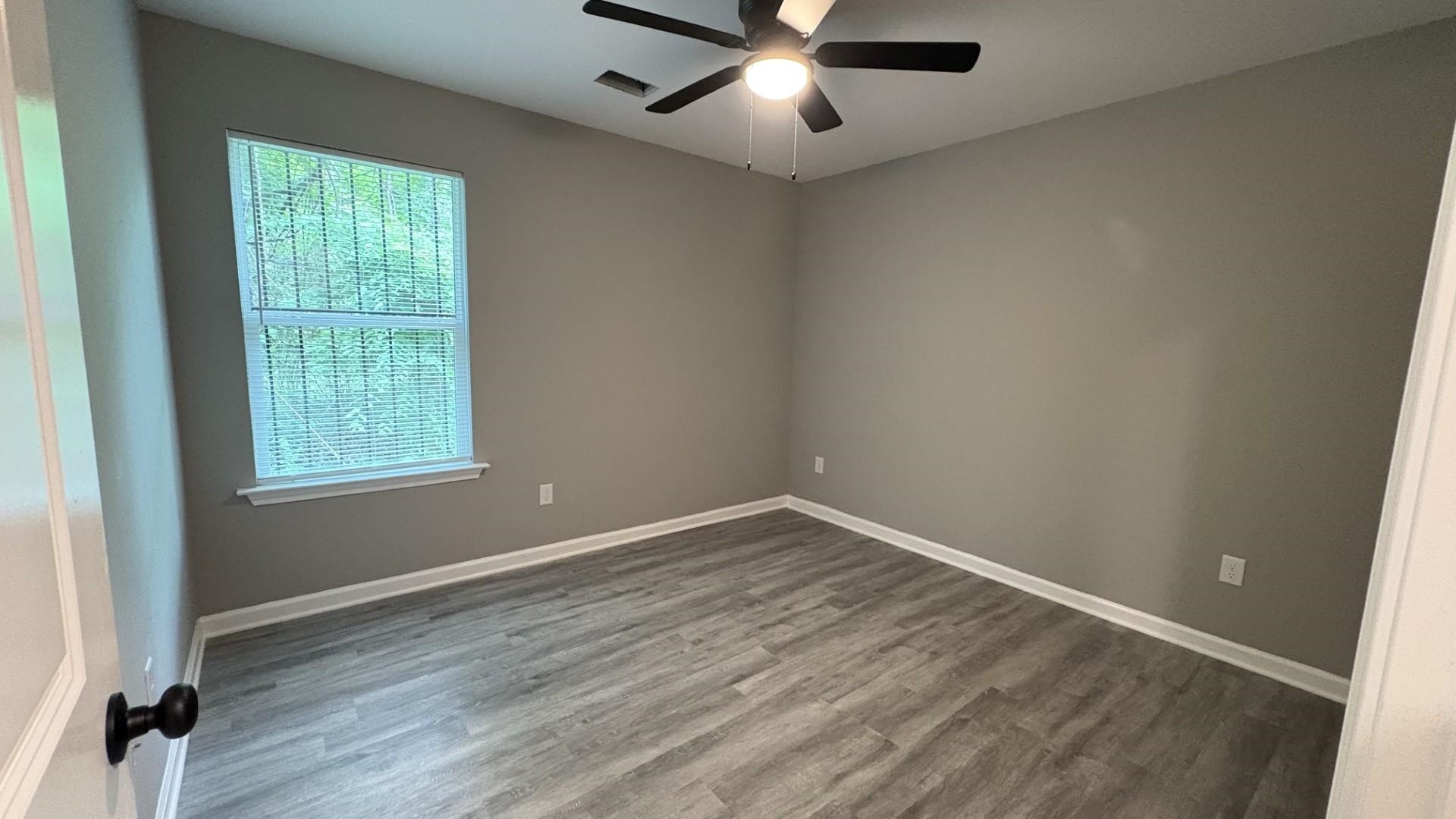 643 Kent Street Memphis, TN 38111 - Photo 5 of 14 Room featuring neutral wall paint, wood-finish plank flooring, and a ceiling fan with integrated lighting