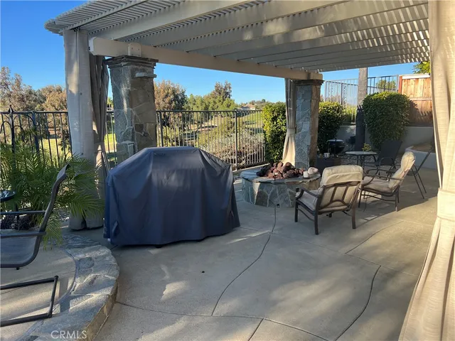 a living room with furniture tv and a floor to ceiling window
