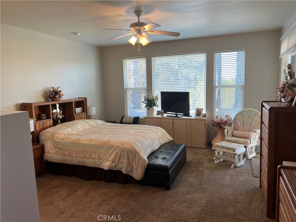 31458 Inverness Court Temecula, CA 92591 - Photo 18 of 33 a bedroom with a bed flat screen tv and a large window