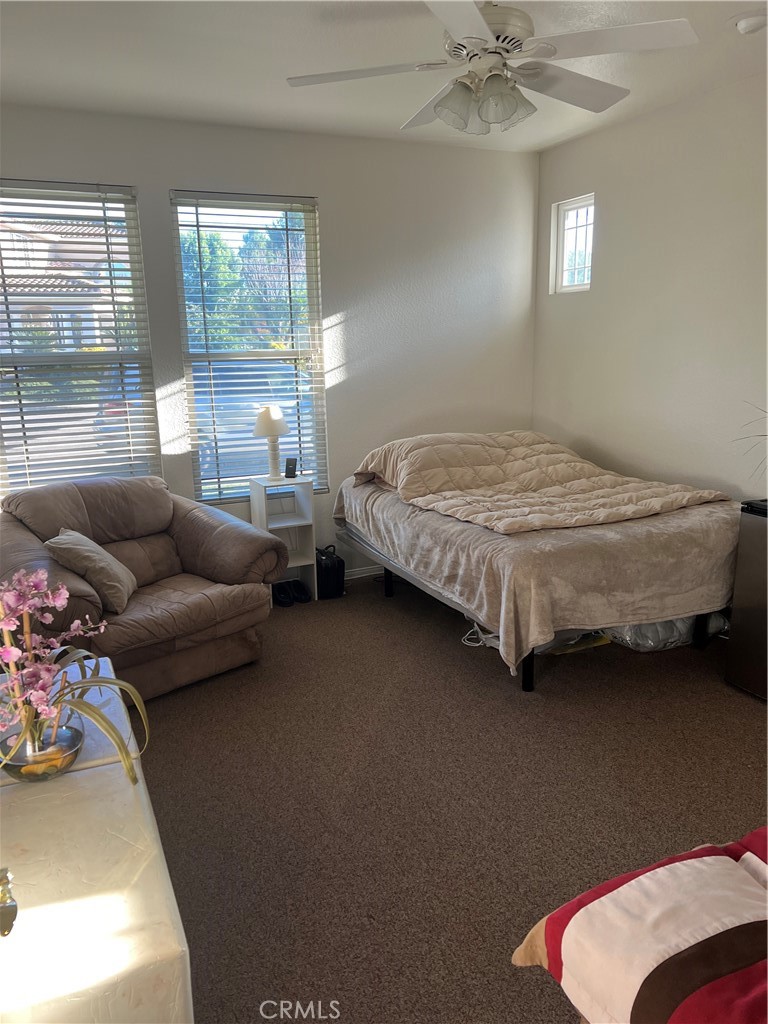 31458 Inverness Court Temecula, CA 92591 - Photo 27 of 33 a bedroom with bed couch and window