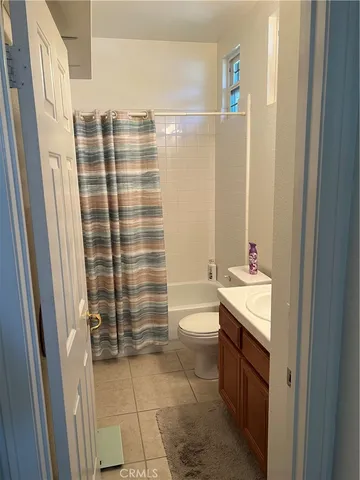 a bathroom with a sink toilet and mirror