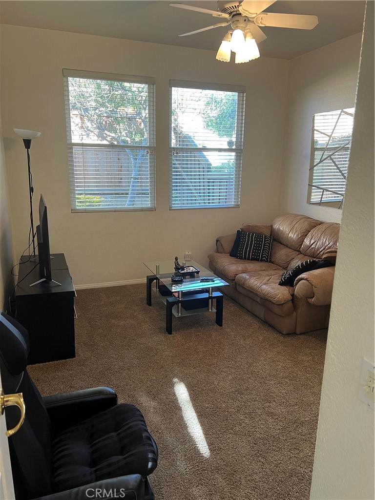 31458 Inverness Court Temecula, CA 92591 - Photo 30 of 33 a living room with furniture and a chandelier
